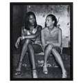Wownic fashion icon poster featuring two models seated together in a candid black-and-white editorial portrait
